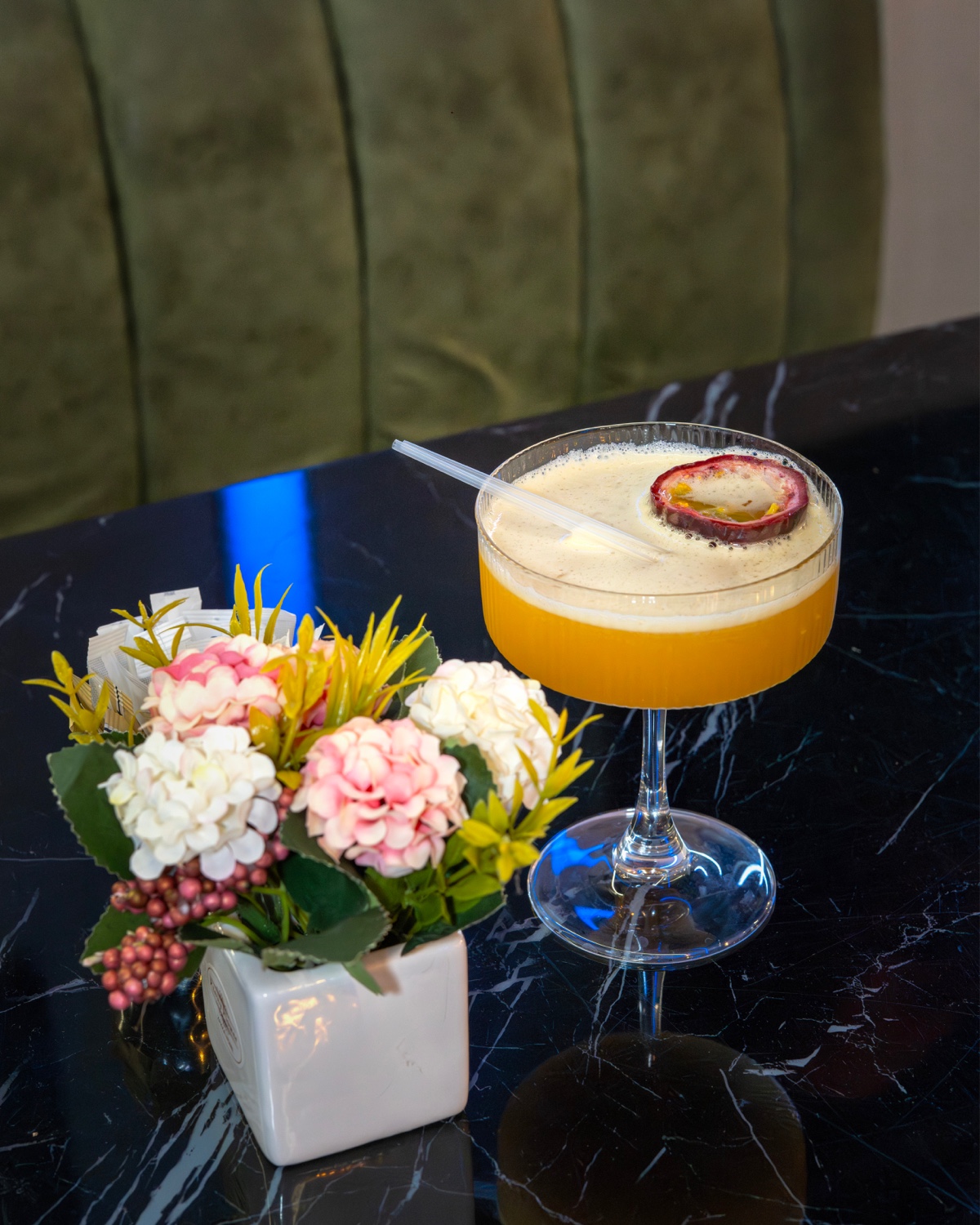 Pornstar martini on the marble bar with the green velvet bench behind