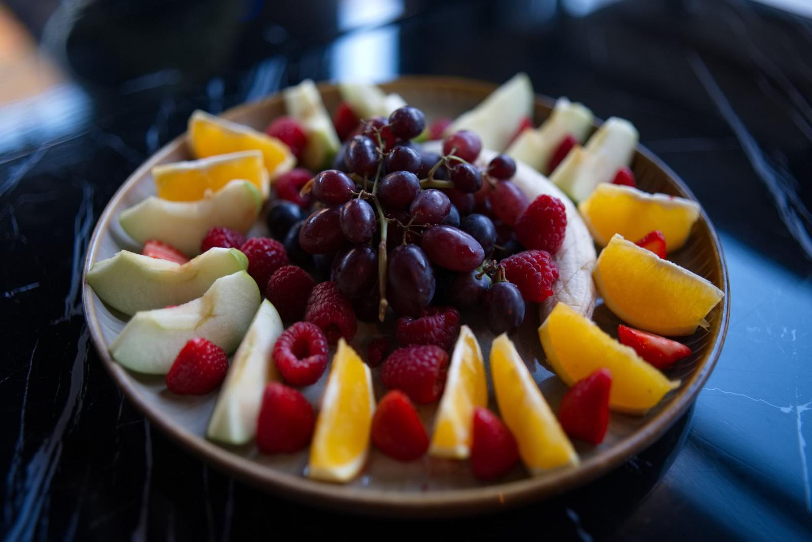 Seasonal fruit platter — grapes, melon, berries, orange